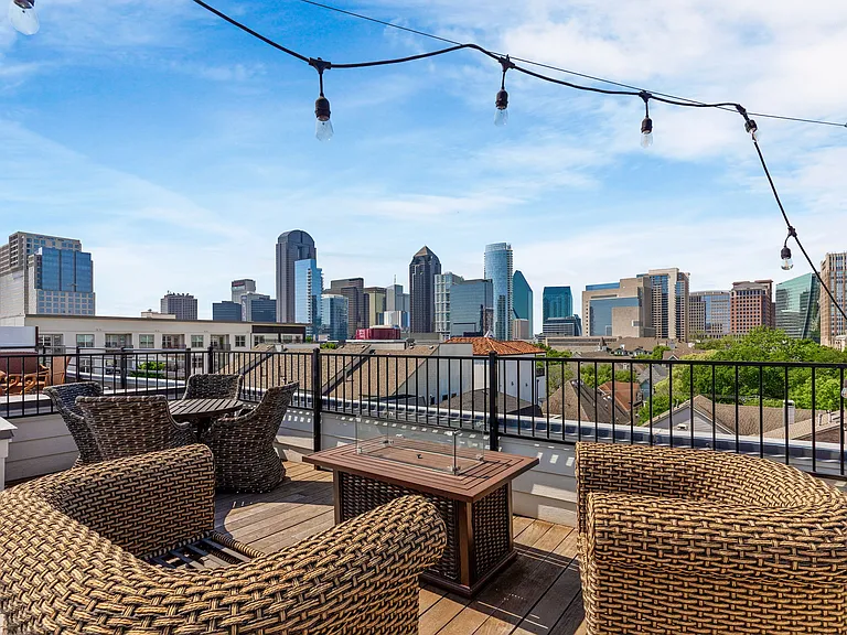 Experience the ultimate Dallas skyline views from our expansive private rooftop deck.