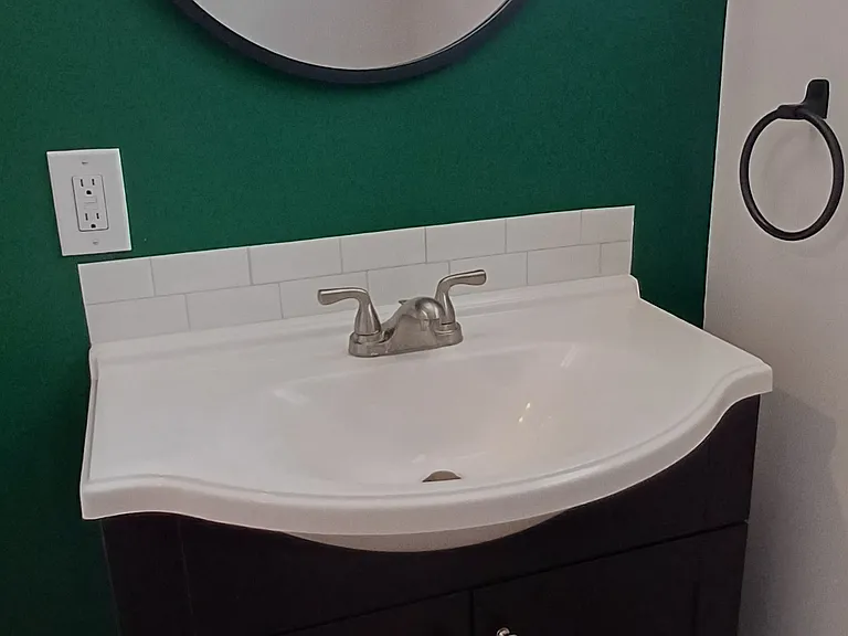 Basement half bath vanity off family room.