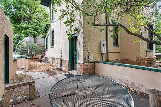 Patio with courtyard surround, adjacent to apartment entry door.