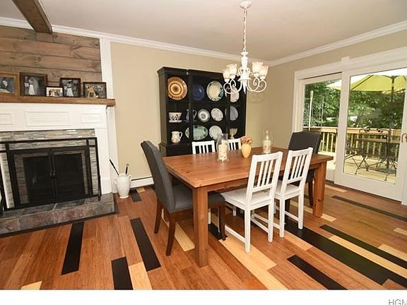 Stone fireplace set between living room and dining room.