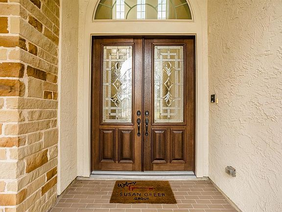 The gated archway leads to the beautiful wood and leaded glass double front doors welcoming you and guests in to this beautiful home.