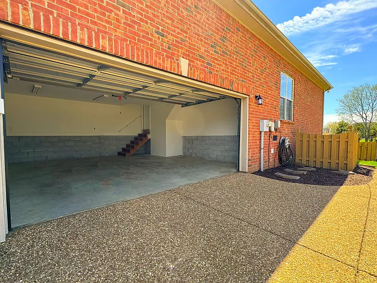 Large garage with space for two cars a lawnmower, motorcycle and storage