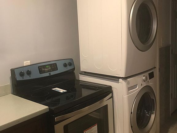 Kitchen showing stove, washer and dryer