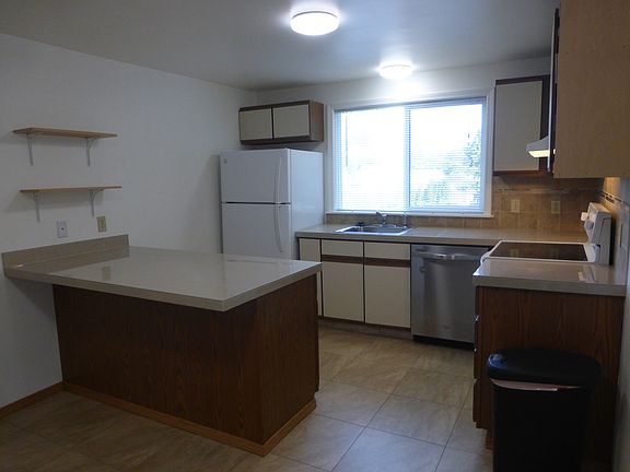 Wall shelves in kitchen give extra storage space.