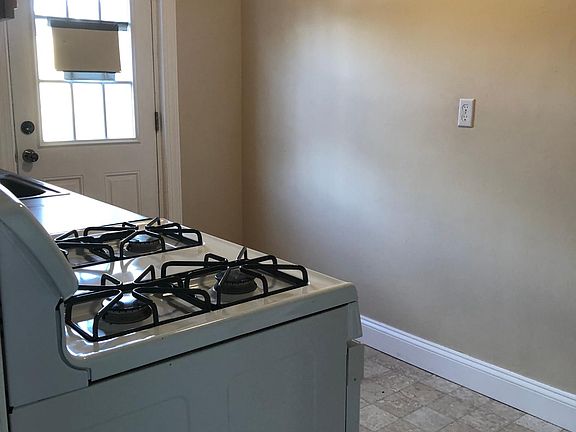 The kitchen, from the dining room. The door opens to the back yard, and your off-the-road parking space.