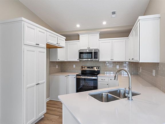Gleaming stone countertops and classic cabinetry e