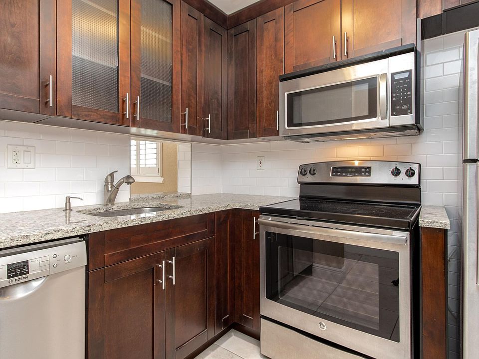 Recently updated chef's kitchen with high-end appliances, beautiful solid wood accents, and marble countertops.