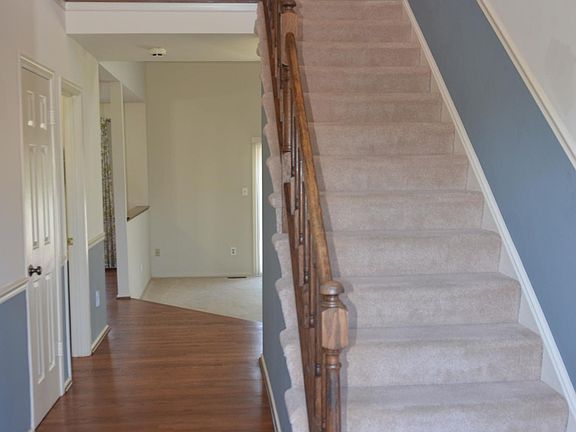 View from entrance . Living room entrance on the left (not seen in picture), closet, half bath, at the end of hallway, Family room on right side and Kitchen on left