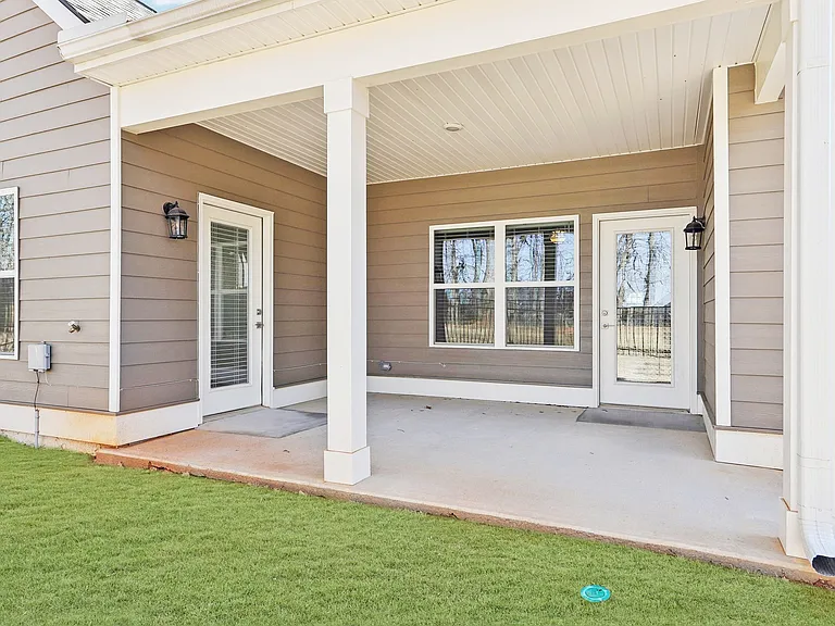 Covered patio on the exterior of the Maxton home.