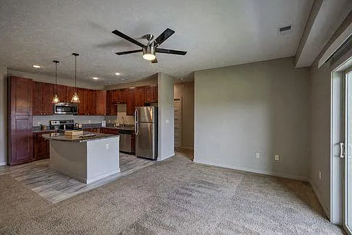 Open concept living room with balcony doors.