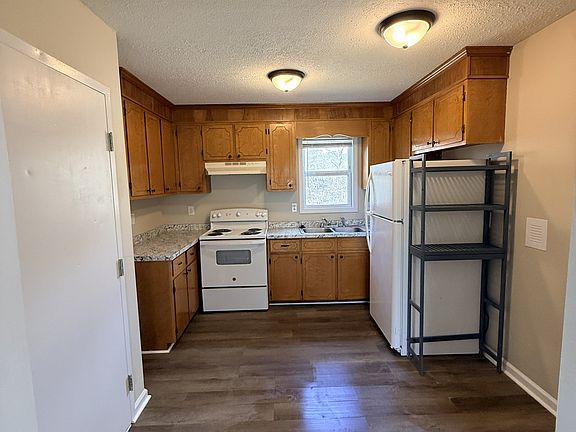 newly painted kitchen with new countertops and an all-in-one washer and dryer