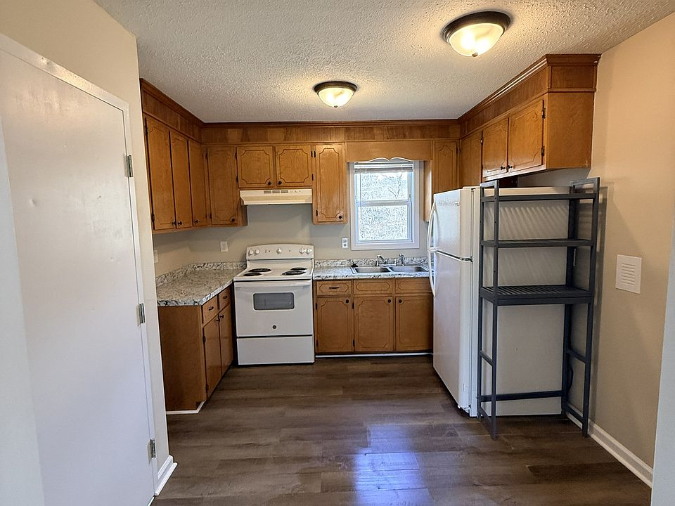 newly painted kitchen with new countertops and an all-in-one washer and dryer