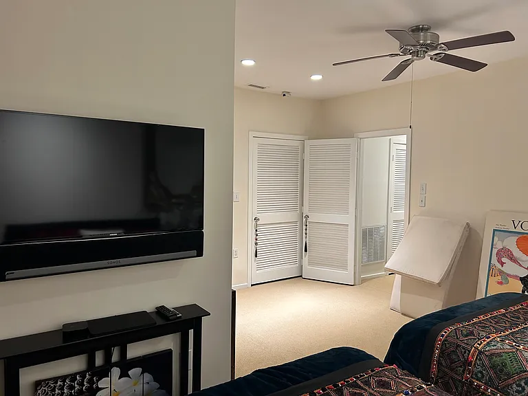 Bedroom #2 - TV and view from rear of the room leading to the private patio.