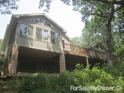 Back of house.
						:
						Looking up from the riverfront lawn to sunrooms and upper deck.
