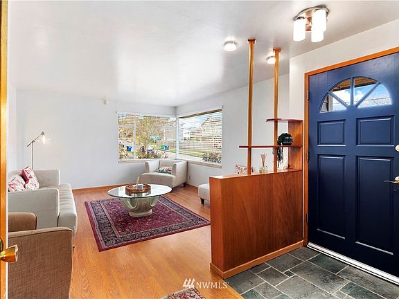 Entry opens to the living room on the right and the dining area and kitchen to the left.