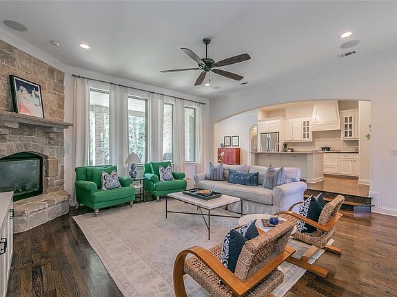 Beautiful open living space with floor to ceiling windows overlooking the serene backyard.