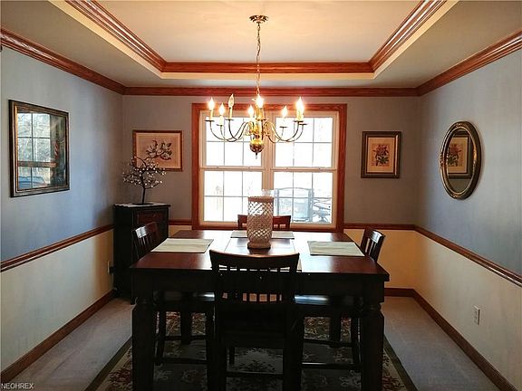 Beautiful recessed ceiling and extra molding bring warmth and character to the formal DR.
