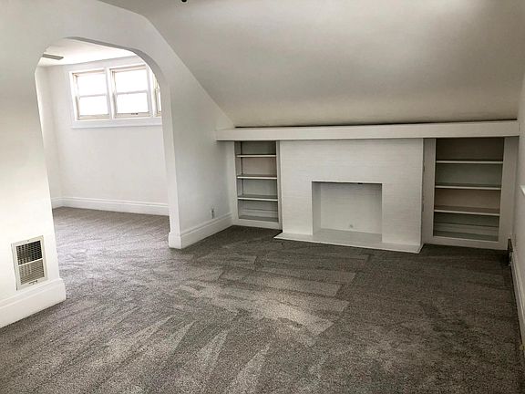 New carpeting and fresh paint throughout unit. Living room features decorative fireplace with built ins and access to private po