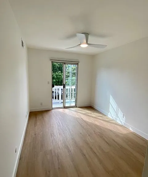 Bedroom 4 with view of balcony and street.