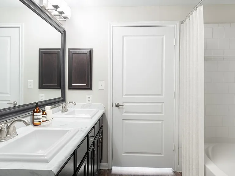 Bath with espresso cabinetry, quartz or granite countertop, and hard surface vinyl plank flooring