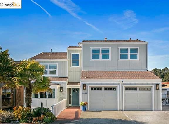 Front with large 2 door garage, with sink, extra dishwasher and plenty of cabinets in it.