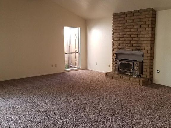This family room has it all, lots of light, vaulted ceiling with a beautiful beam, fireplace and bar for your entertaining.