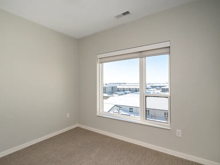 Bright and cozy room featuring a large window with a scenic view, perfect for natural light lovers. Bright and cozy room featuring a large window with a scenic view, perfect for natural light lovers.