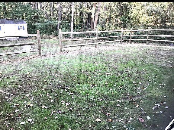 Fenced play yard w/dog door 