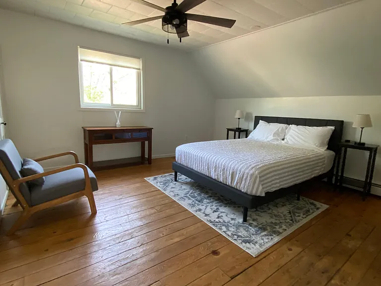 Master Bedroom containing Queen Bed and chair.