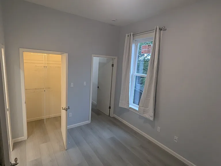 Office area looking into closet and doorway into living room. New windows and curtains and lighting.