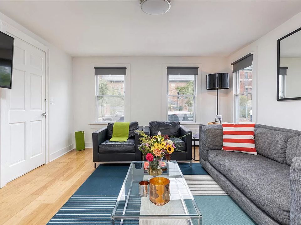 Living room with views of the Hudson Library and wall-mounted TV (included)