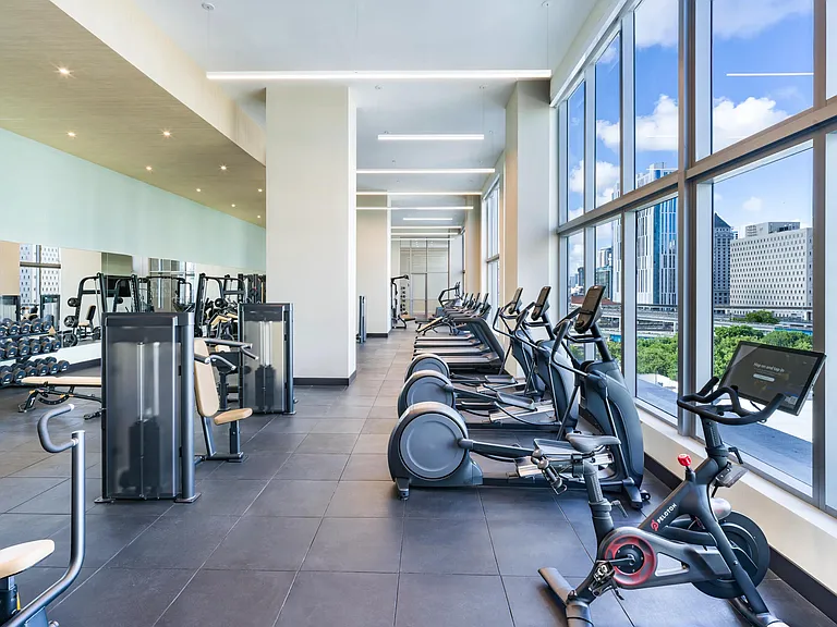 Stay active with cutting-edge equipment and downtown views at Modera Riverside's light-filled fitness center.