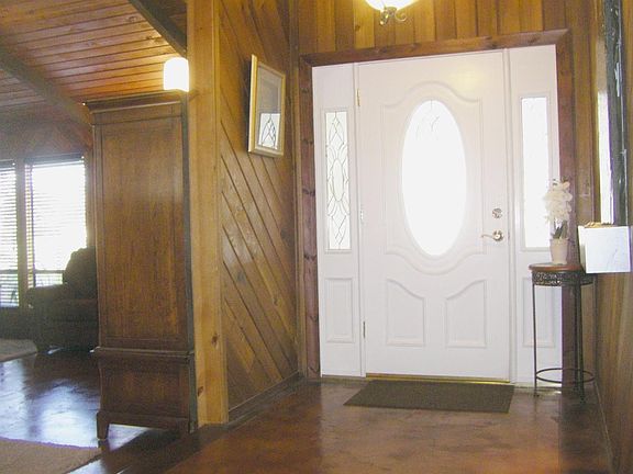 Once inside, you notice the cabin-like feel throughout. From the stained concrete floors to the tongue and grove wall paneling, to the vaulted exposed beam ceilings.