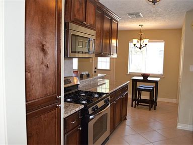 Beautifully updated kitchen with custom cabinets, granite, stainless steel appliances, and plenty of