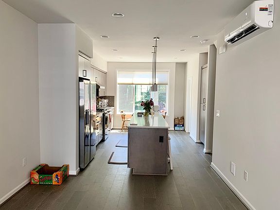 Dining room & Kitchen. A half bathroom is on the right-hand side by the window.
