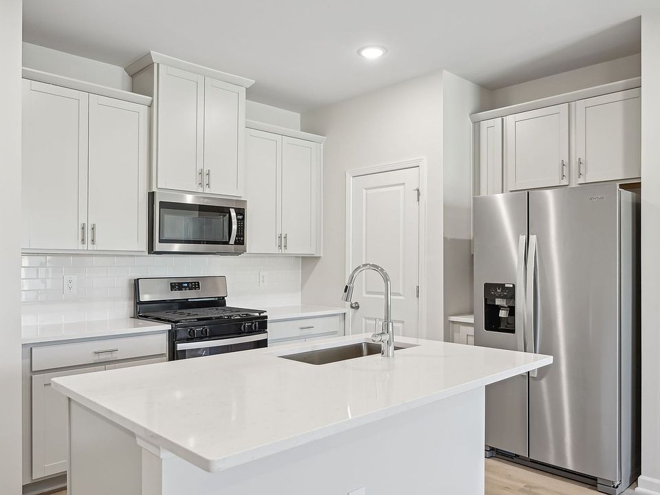 The spacious kitchen island is at the heart of the open-concept first floor.