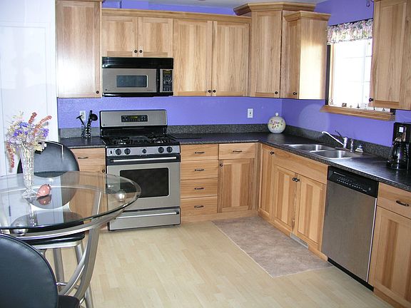 Updated kitchen with Hickory cabinets and stainless steel appliances.