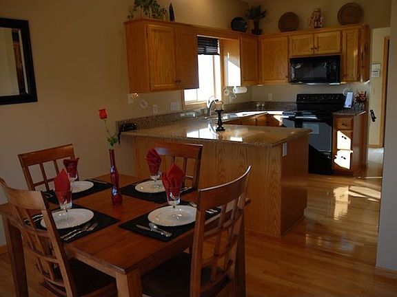 Dining and upgraded kitchen with beautiful oak hardwood floors.
