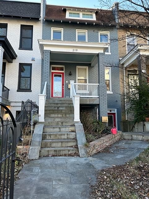 Three bedroom two bath rowhome with small fenced in front yard and heated slate walkway.