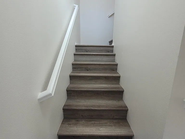 Stairwell up to double primary suites.