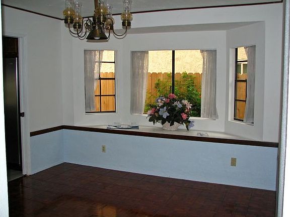 Formal Dining Rm. with teak floor and big bay window