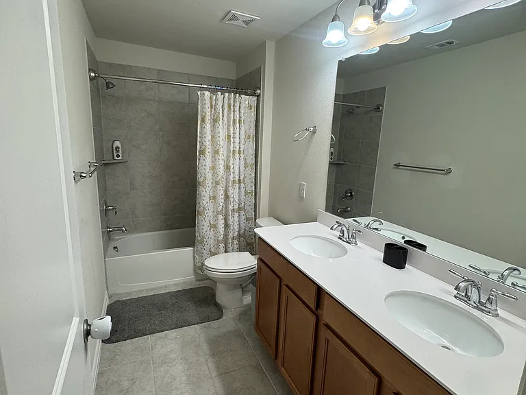 Upstairs bathroom with dual sinks.