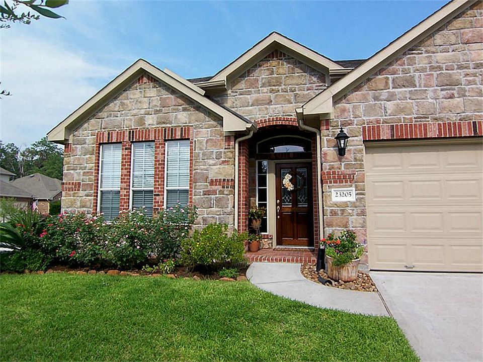 Front walkway to house with beautiful landscaping.