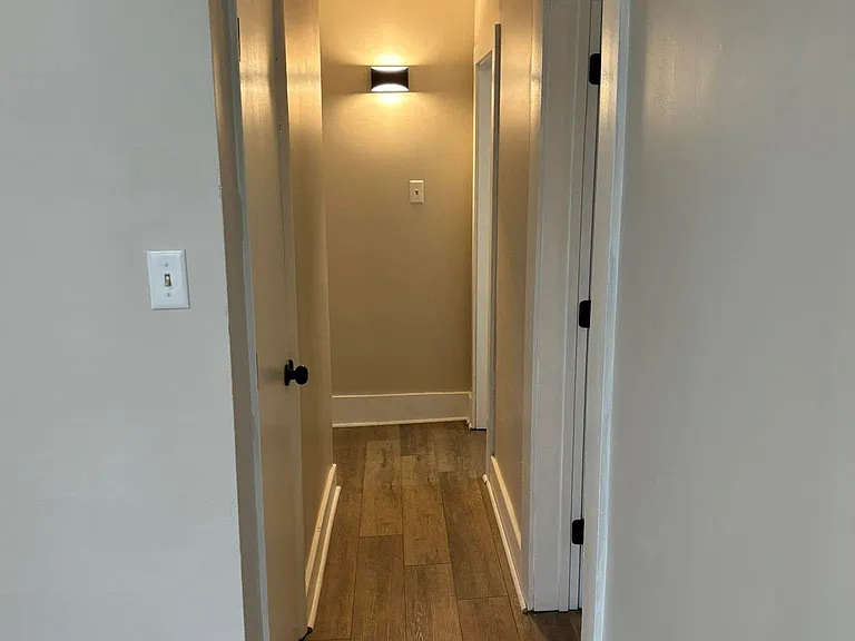 Hallway from living room, bathroom on first right. Smallest bedroom on second right. Hallway to left has two bedrooms.