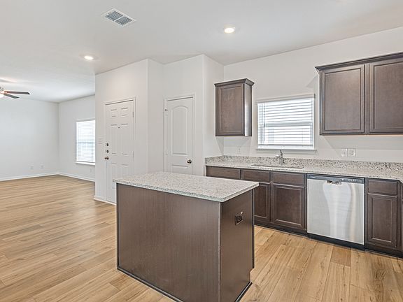 Upgraded kitchen with an island and granite countertops.