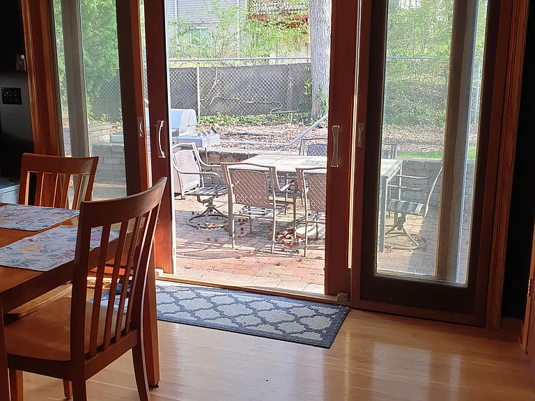 Double glass sliding door to paved back patio