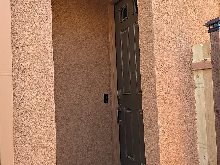 Secure, private entrance featuring keyless smart lock access, integrated security camera, and automated smart lighting with custom schedules. Tech-enabled convenience and peace of mind, ready to welcome you.