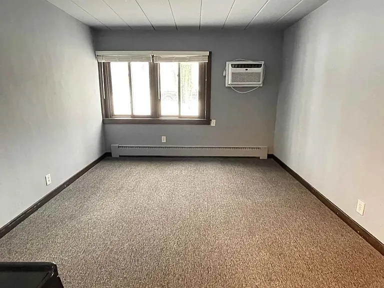 Elevate your living experience at LS Capital Group with this spacious, sunlit room featuring large windows and ample natural light. Perfect for personalizing to fit your style. Schedule a visit today to envision your new home!