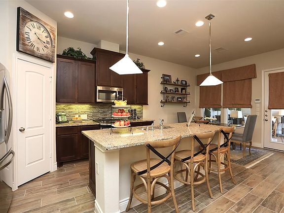 Walk in Pantry, beautiful backsplash and custom window treatments or shutters throughout!