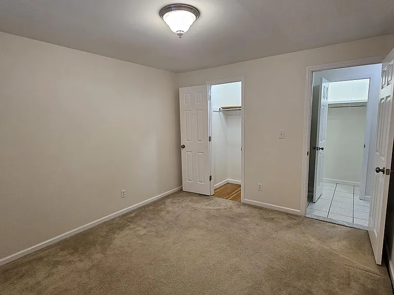 Second carpeted bedroom with deep closet.